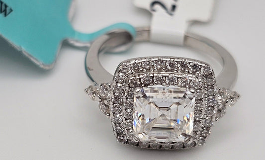 Silver ring with a large diamond on a light gray background