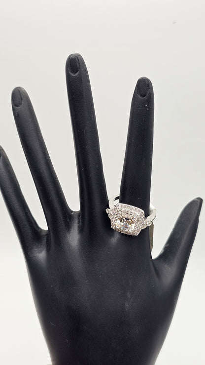 Diamond ring on a black mannequin hand against a white background