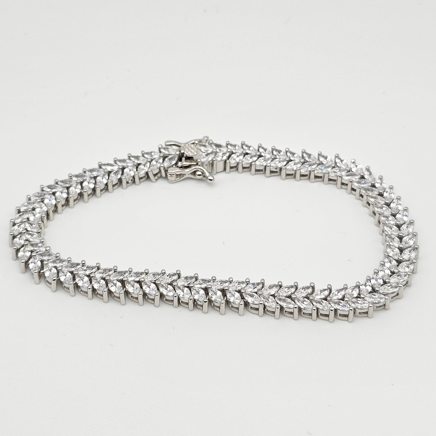 Silver chain necklace on a light gray background