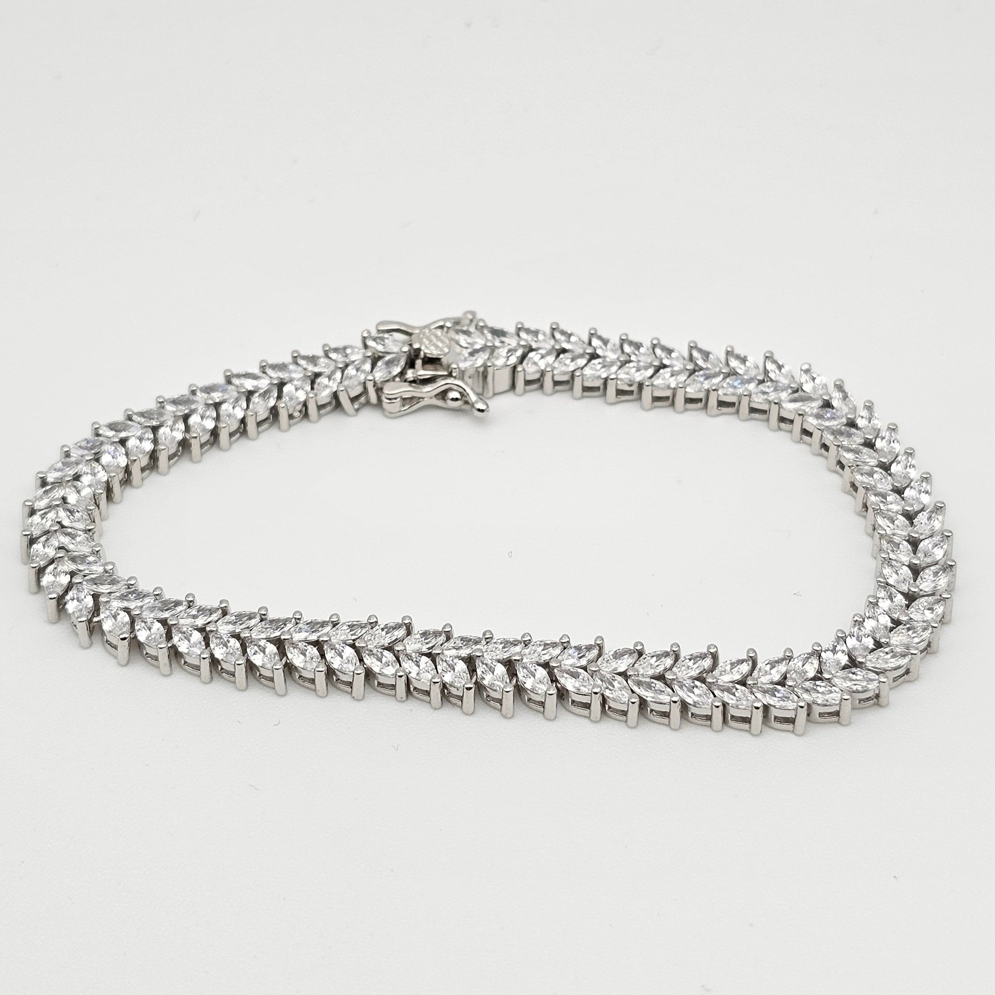 Silver chain necklace on a light gray background