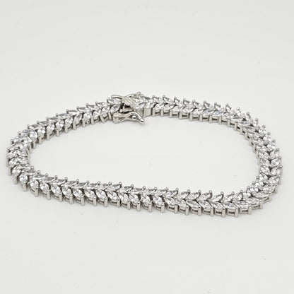 Silver chain necklace on a light gray background